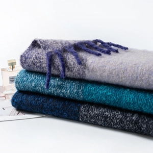 Detailed texture of thick mohair plaid scarves with long fringe in multiple colors