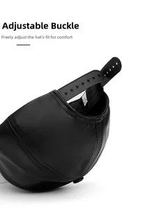 Detailed view of adjustable snapback closure on black faux leather baseball cap with stitching