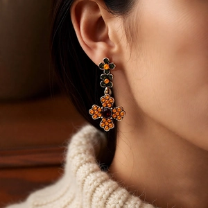 Macro shot of vintage style multi-layer cross floral earrings with colorful gemstones