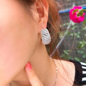 Luxurious silver U-shape hoop earrings with sparkling cubic zirconia on a female model
