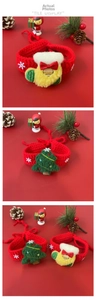 Detail showing handmade crochet pet Christmas collar with festive tree and stocking decor