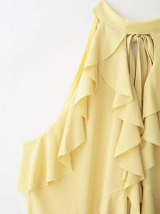 Detail of yellow halter neck top with layered ruffles and soft chiffon texture