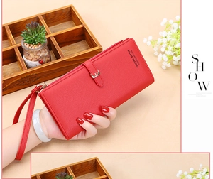 Detail of red pebbled leather women long wallet with wristlet and zipper closure
