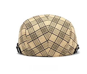 Detail view of cotton plaid newsboy cap back with black adjustable strap and metal buckle