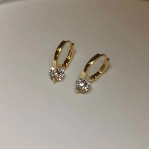 Detail view of S925 sterling silver hoop earrings with sparkling round cubic zirconia