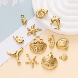 Macro view of gold-plated stainless steel ocean charms including starfish and shells