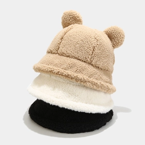 Detailed texture of sherpa fleece bucket hats with cute bear ears in brown, white and black