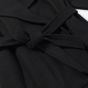Slim fit black wool coat with textured woven fabric and waist tie detail
