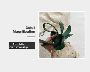 Macro detail of pineapple crossbody bag with metallic rivets and green leaf design