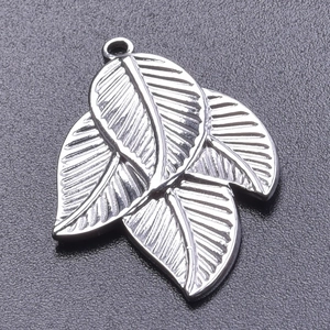 Detailed macro view of silver leaf pendant showing realistic leaf vein textures and metallic finish