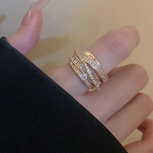 Detailed view of layered gold-plated ring with shimmering cubic zirconia on hand