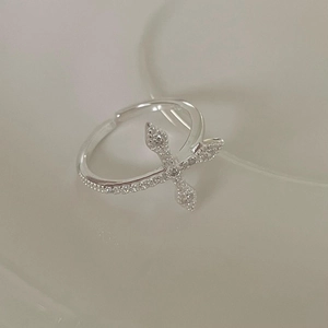 Detail of 925 sterling silver cross open ring with sparkling small diamonds