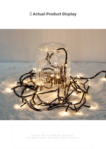 Warm white LED string lights inside a vertical ribbed glass jar on snowy white fabric