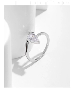 Macro shot of s925 silver pear-cut droplet ring with sparkling pavé-set zircons