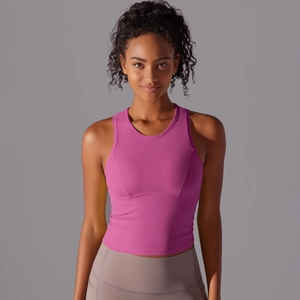 Détail du haut de yoga rose vif montrant l'encolure ronde et les coutures de maintien
