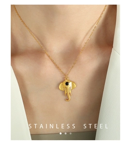 Close-up of golden stainless steel elephant pendant necklace on a female model
