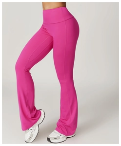 Close-up of hot pink flared yoga pants with high waist and tummy control on model