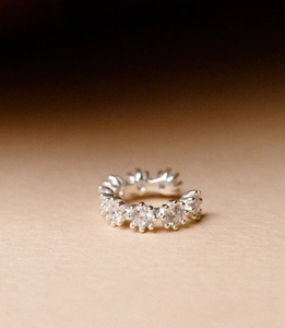 Macro detail of vintage silver ear cuff with sparkling rows of round zirconia stones