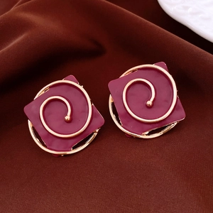 Detailed close-up of retro square burgundy enamel earrings with gold spiral patterns