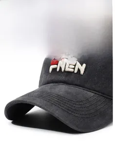 Close-up of stereoscopic FNEN letter embroidery on washed dark grey baseball cap brim