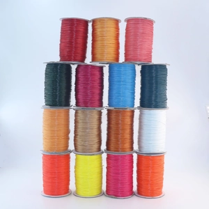Close-up of assorted vibrant colorful DIY braided wax cords in rolls for jewelry making