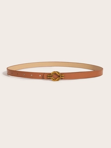 Detail of a brown leather belt featuring a golden metallic knot buckle on white background