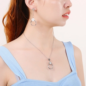 Elegant silver stainless steel jewelry set featuring hollow circular rhinestone pendants