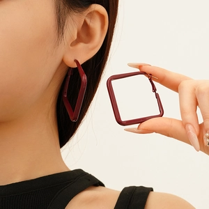 Deep red square geometric earrings in polished lacquer finish for a minimalist modern look