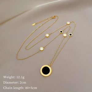Macro detail of Roman numeral engraving on black and white reversible pendant necklace