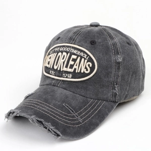 Close-up of distressed vintage grey cap with embroidered Let the Good Times Roll patch