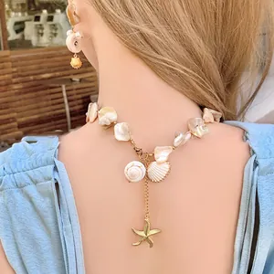 Detail of seashell and starfish necklace set worn by a model in a beach resort style