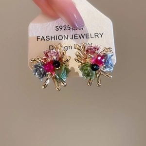Macro shot of colorful resin flower stud earrings with S925 silver needles detail