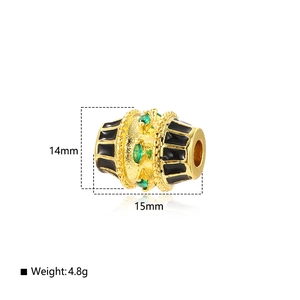 Detail of 14mm gold-plated oval bead with black enamel and green zircon for jewelry DIY