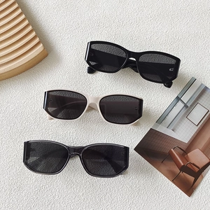 Three pairs of vintage rectangle sunglasses in black, beige, and transparent grey