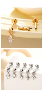 Detailed macro view of titanium labret studs with zircon drop and flower pendants