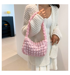 Detailed view of pink bubble textured shoulder bag worn by model in light aesthetic