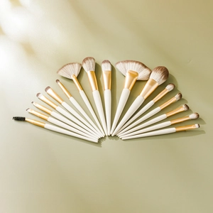 Detail of 14-piece makeup brush set with white handles and brown gradient synthetic bristles