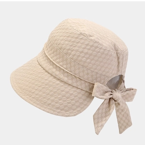 Women's foldable beige sun hat with bow decoration and textured fabric finish