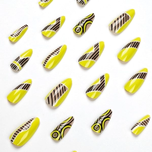 Yellow press-on nails with geometric black stripes and almond shape on white background
