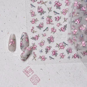 Macro detail of 3D embossed nail stickers featuring elegant Chinese style flowers and birds