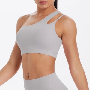 Detail view of light grey asymmetric sports bra with one-shoulder cutout design