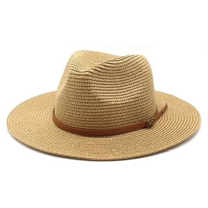 Close-up of natural straw texture and brown faux leather band on a Panama hat