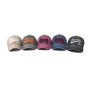 Five assorted colors of vintage washed cotton baseball caps with 3D letter embroidery