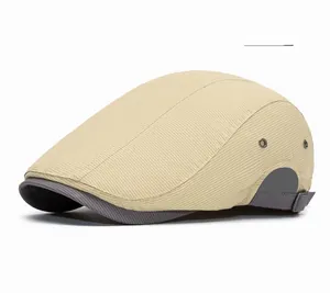 Detail of off-yellow duckbill hat showing fine twill texture and metal eyelets