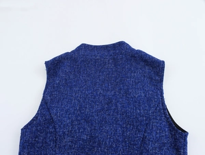 Close-up of blue tweed texture on the sleeveless top back with detailed fabric weave