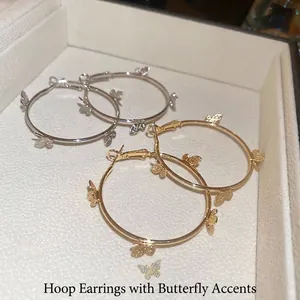 Chic butterfly charm hoop earrings set in polished gold and silver finishes