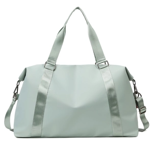 Close-up of mint green waterproof gym bag with reinforced handles and metal buckles