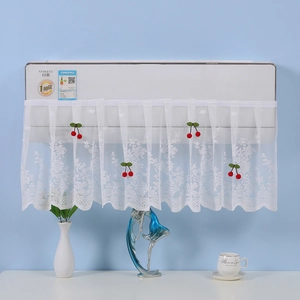 Close-up of white lace air conditioner cover featuring red cherry decor and floral patterns
