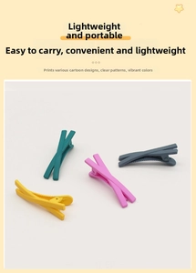Detailed view of matte candy-colored X-shaped hair clips in yellow, pink, and blue colors