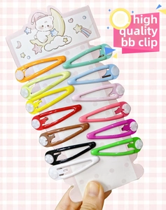 Close-up of 12 colorful metal candy-colored BB snap hair clips on a cartoon display card